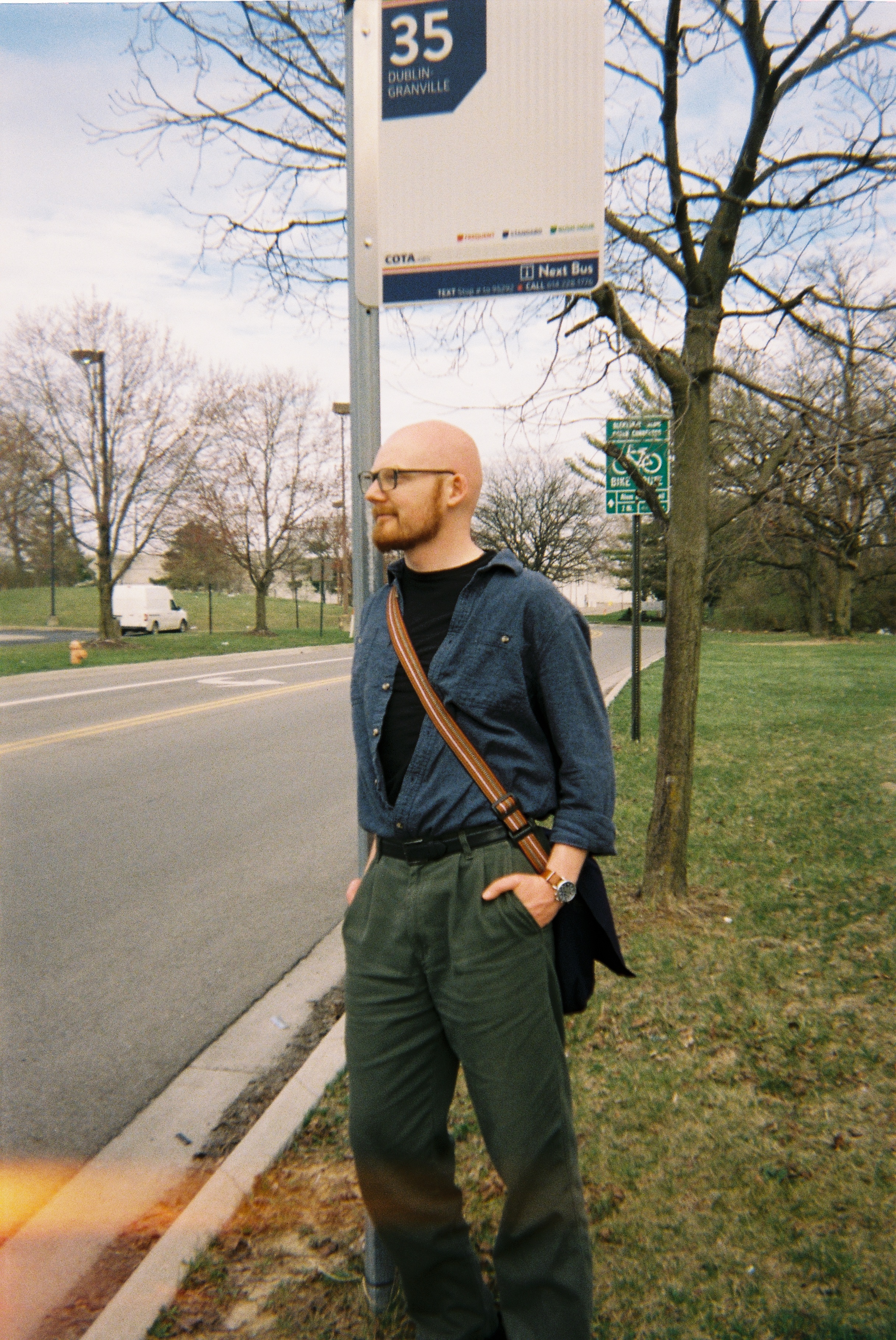 a man standing by a bus stop